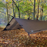 DD Tarp Small set up in autumn forest, providing shelter in wet weather for camping or backpacking.